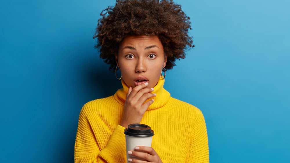 shocked woman holding tea