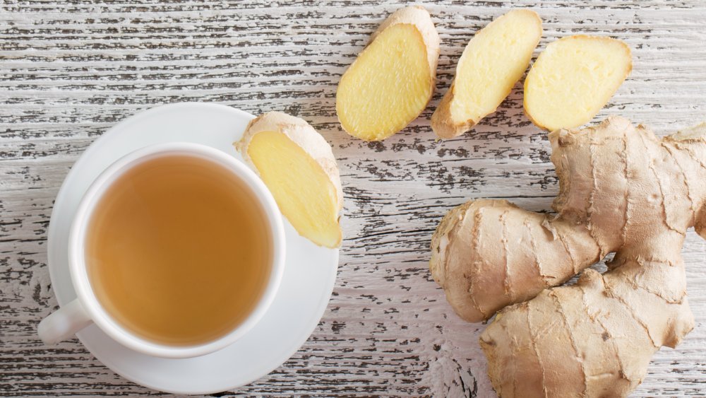 Ginger tea and ginger root on a wooden background