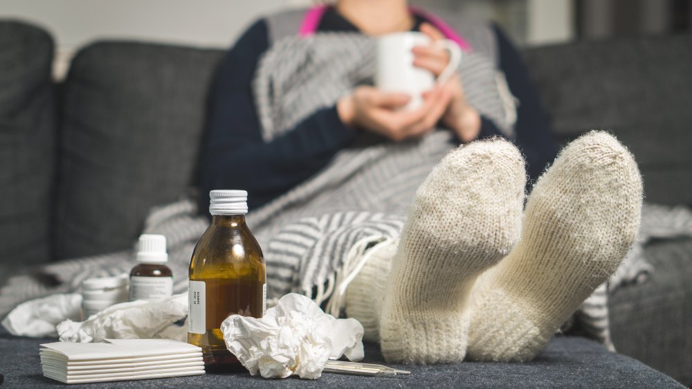 a sick woman drinking hot water