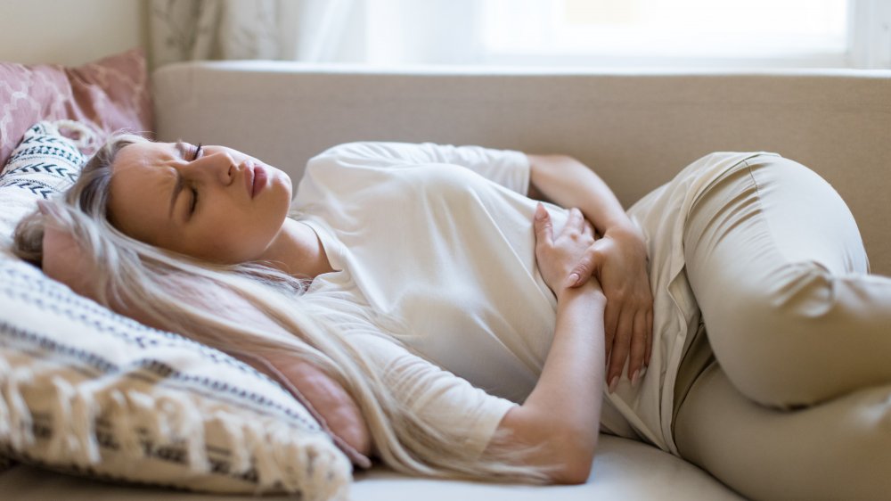 A woman holding her abdomen