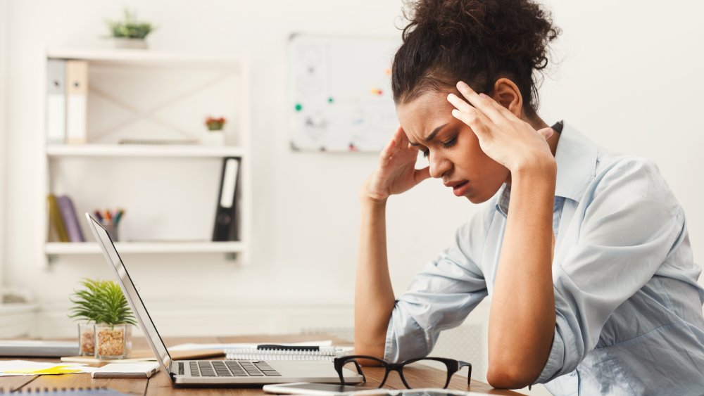 A woman at her desk stressed out