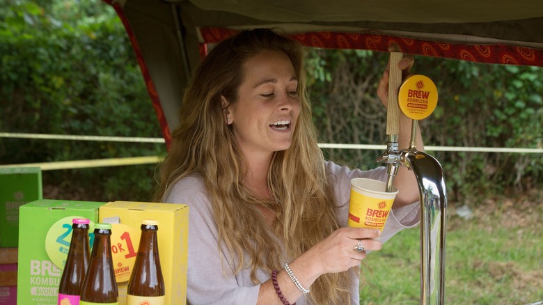 Woman pouring herself kombucha tea