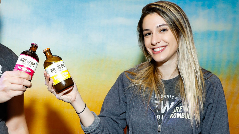 woman holding kombucha tea drink