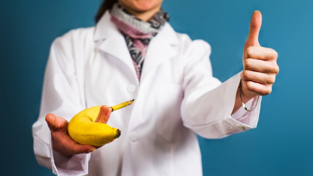 Doctor holding banana