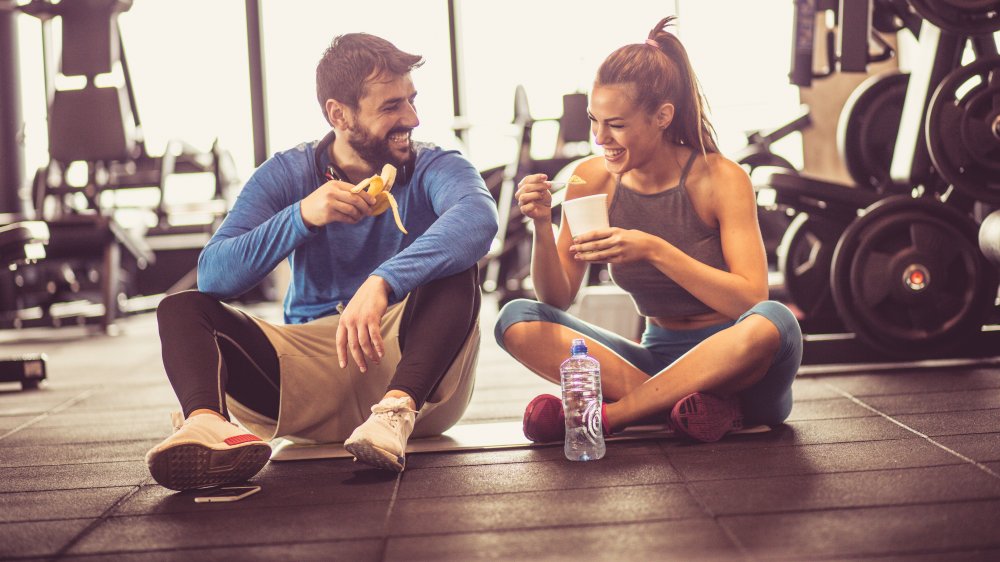 Couple eating banana after working out