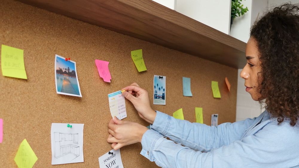 Woman placing notes on a board