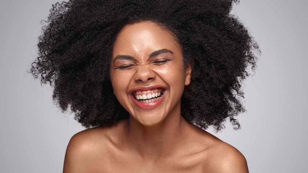 A woman smiling broadly