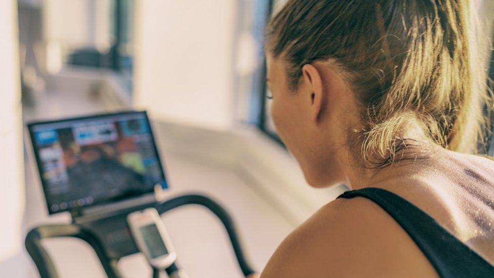 a woman exercising on a stationary bike