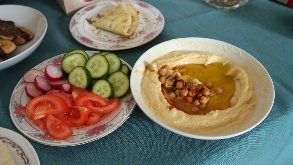 Bowl of hummus and dish of veggies