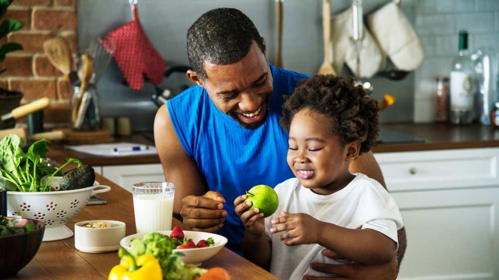 a father and son cooking in a kitchen