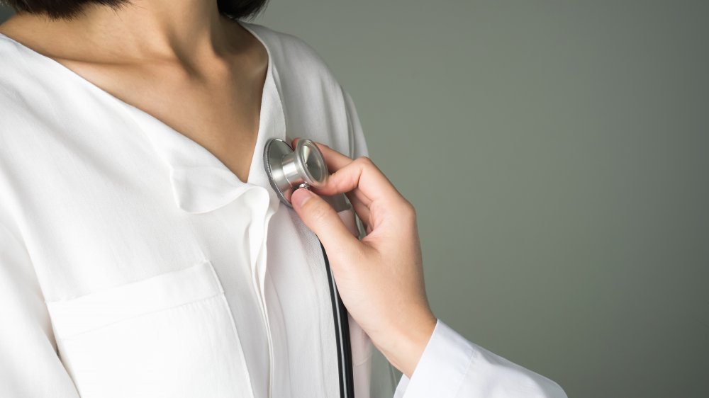 doctor listening to woman's heart