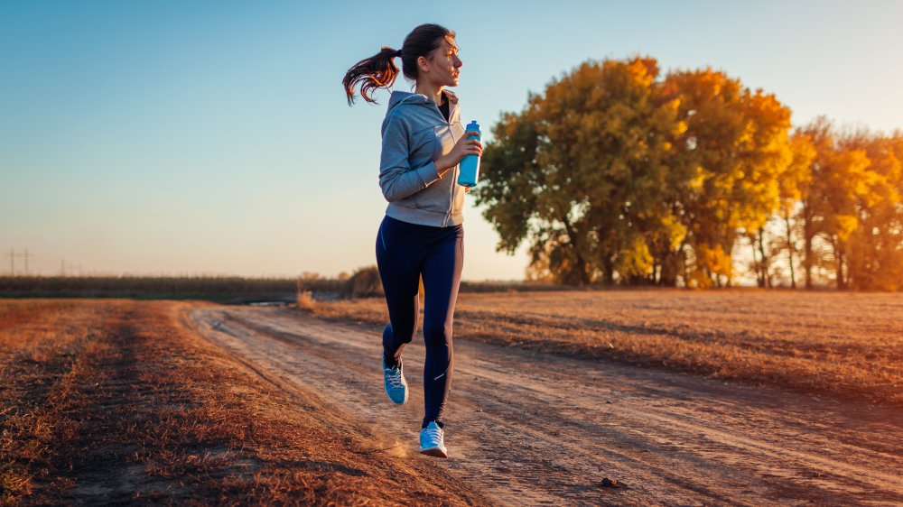 A woman jogging on a country road