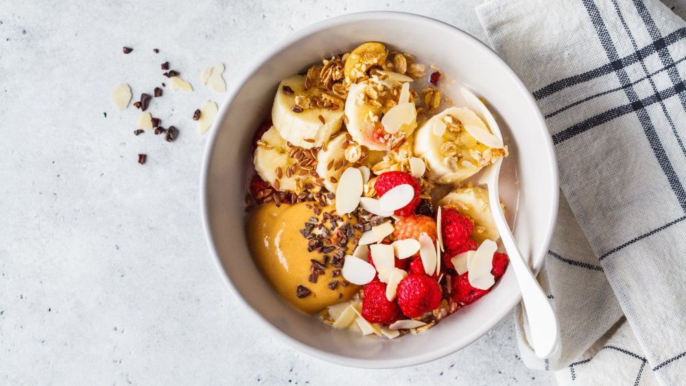 Oatmeal with peanut butter and a variety of toppings in a bowl