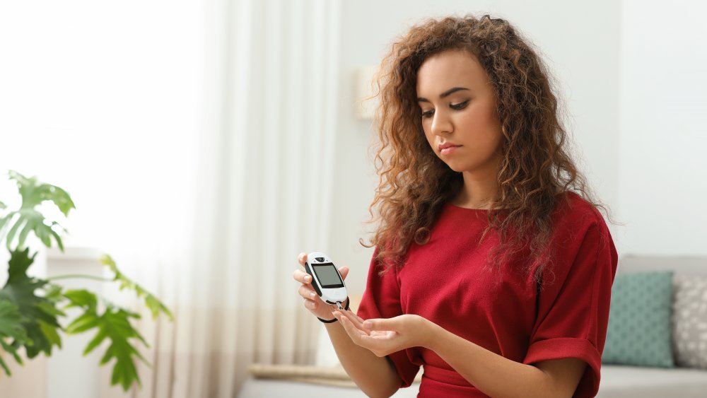 A woman monitoring her blood sugar