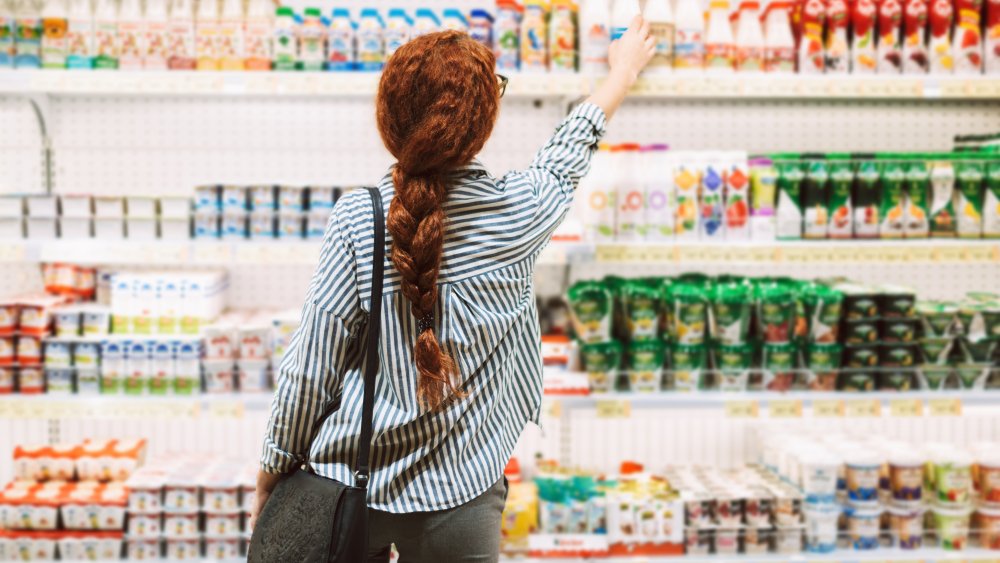 A woman buying yogurt in a store