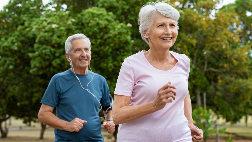 Older woman and man doing cardio