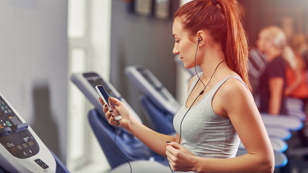 Woman on treadmill with phone