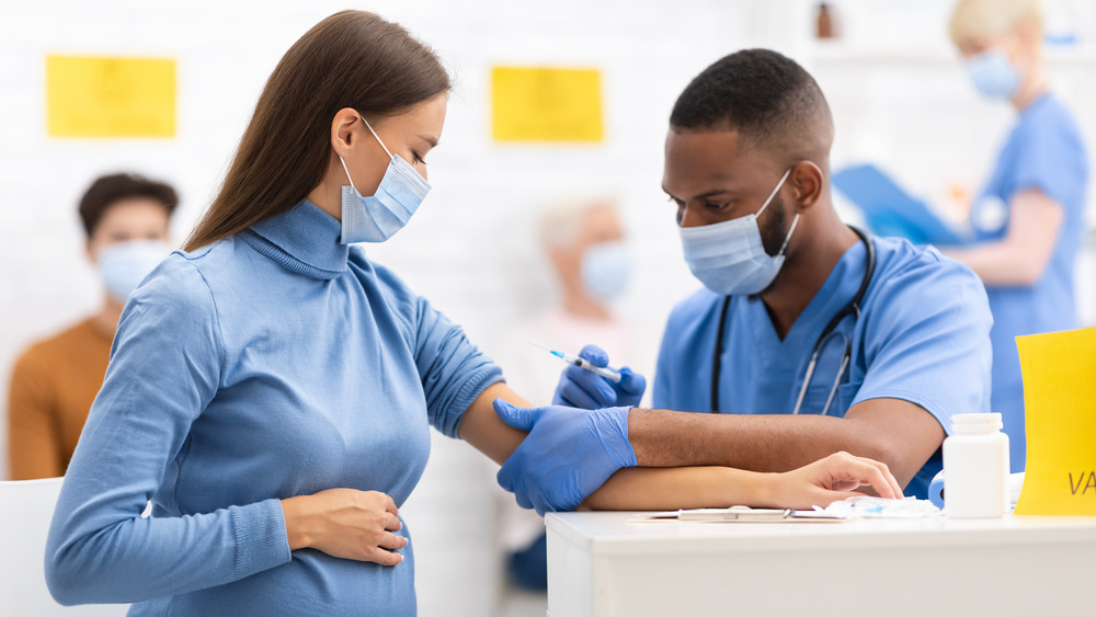 A pregnant woman getting vaccinated