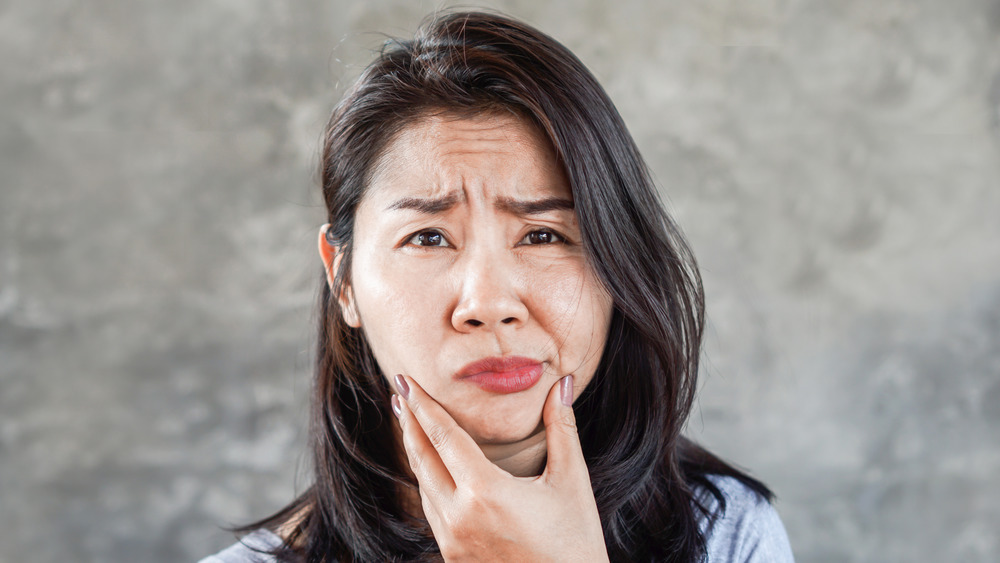 Woman suffering from facial paralysis