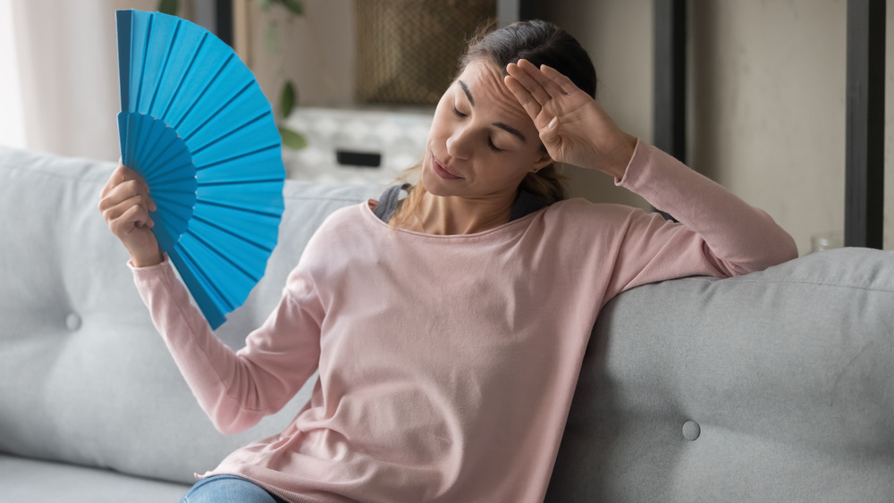 A woman fanning herself