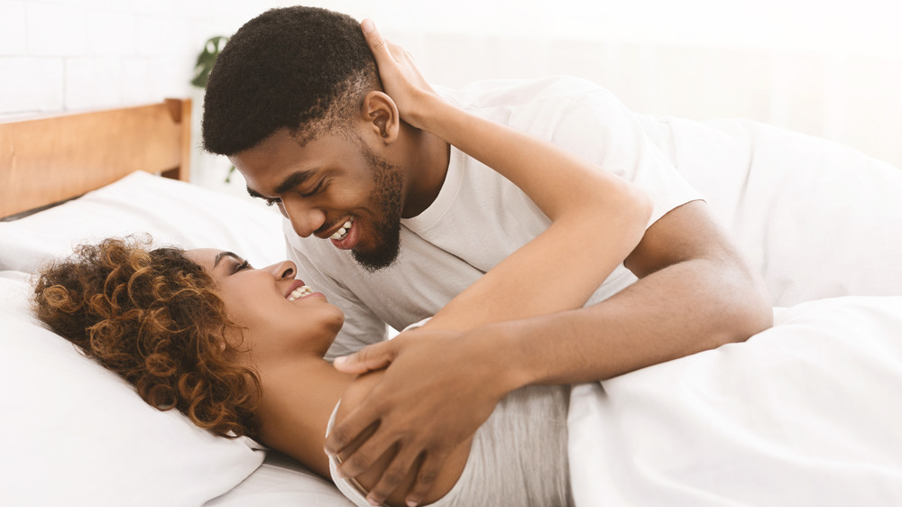 A couple in bed smiling