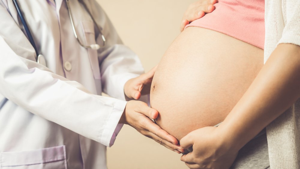 a doctor examining a pregnant woman