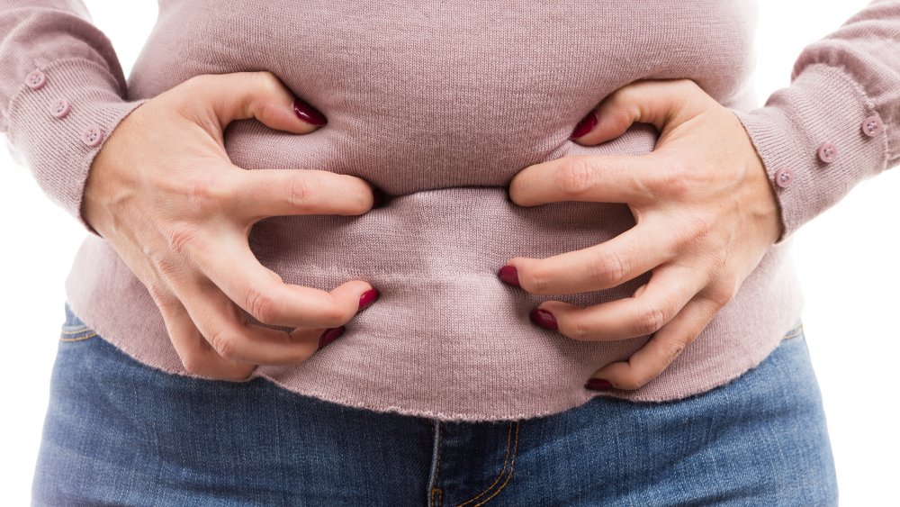 a woman experiencing period bloating