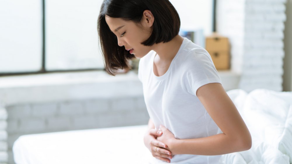 a woman holding her stomach