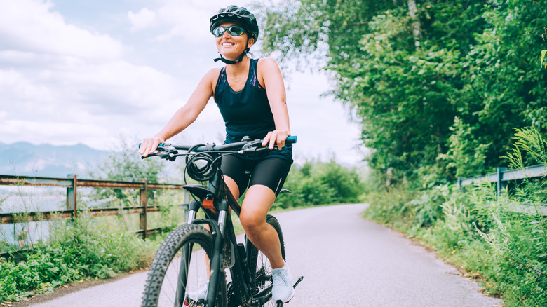 woman smiling while riding bike