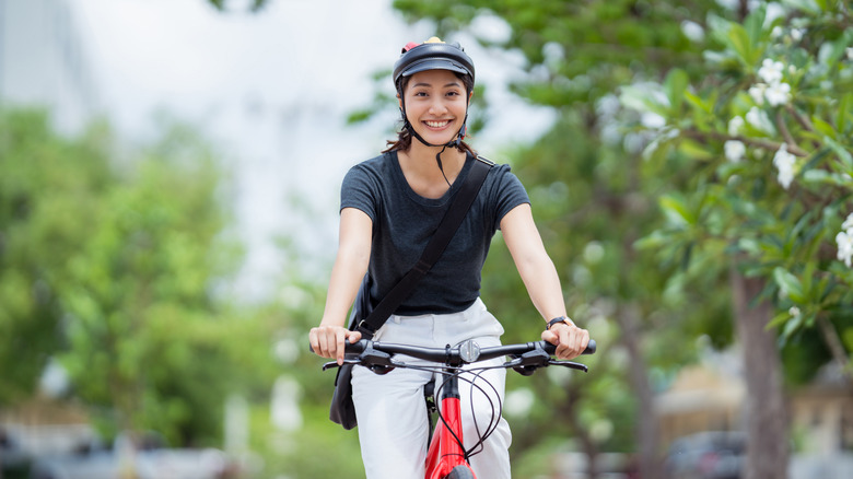 Woman cycling while smiling