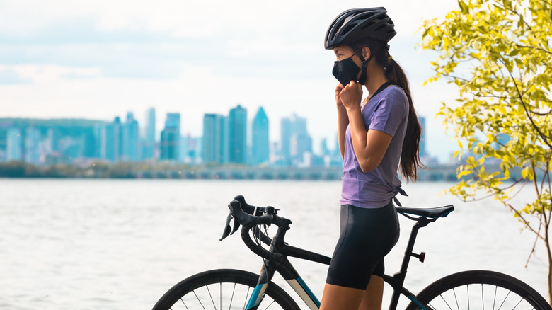 Woman with bike wearing mask