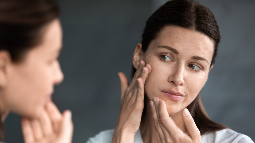 Woman stretching skin on face