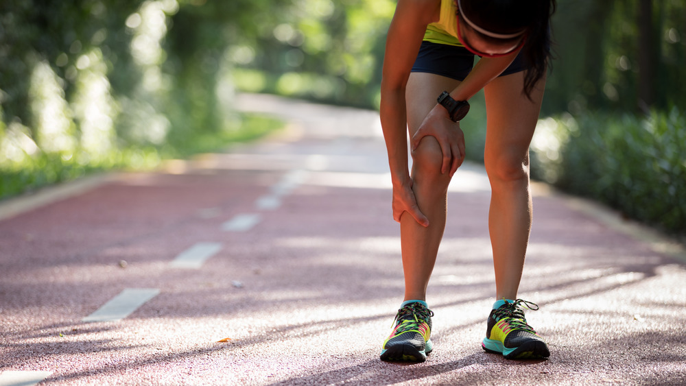 Woman running with sore muscles