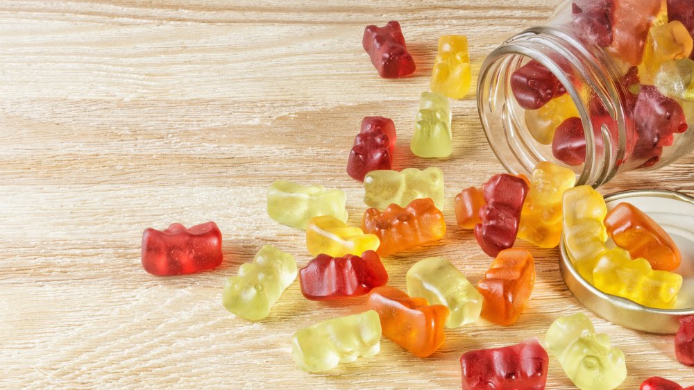 Gummy vitamins spilling out of a jar