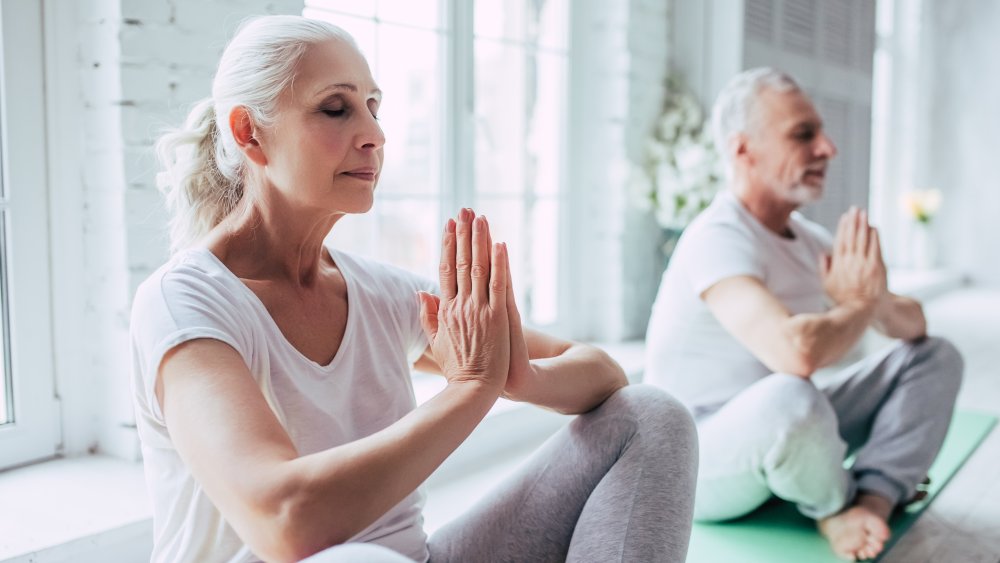 A senior couple doing yoga together