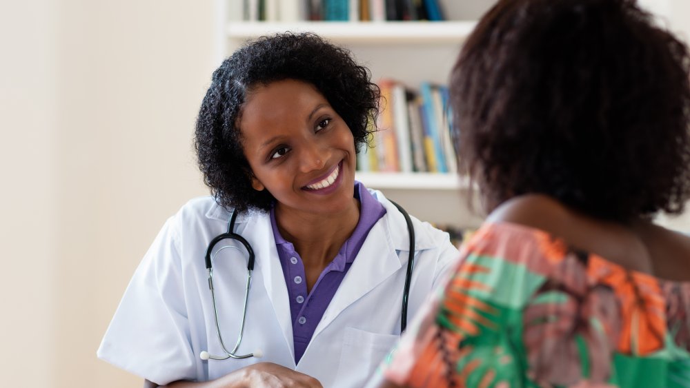 A doctor counseling her patient