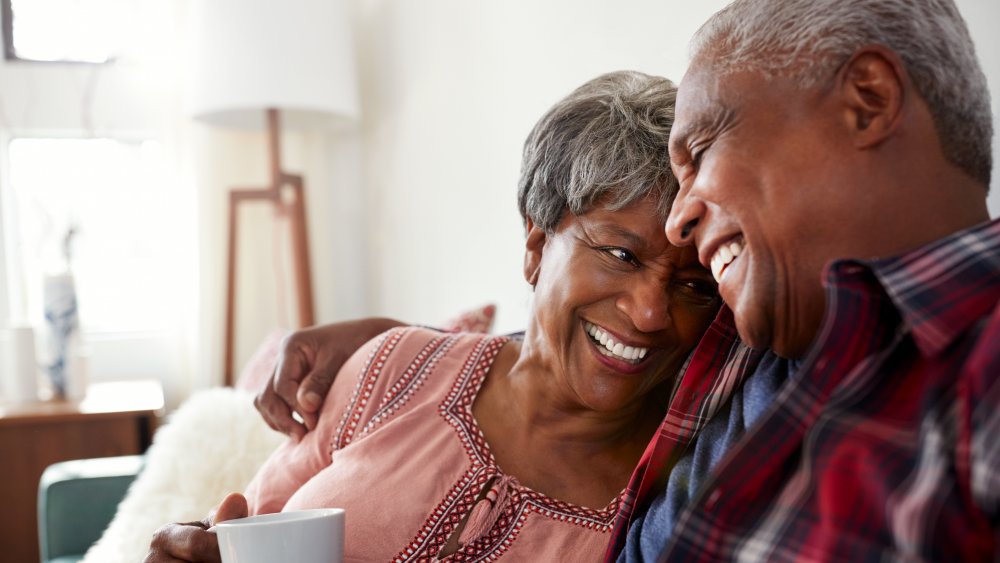 A senior couple, smiling