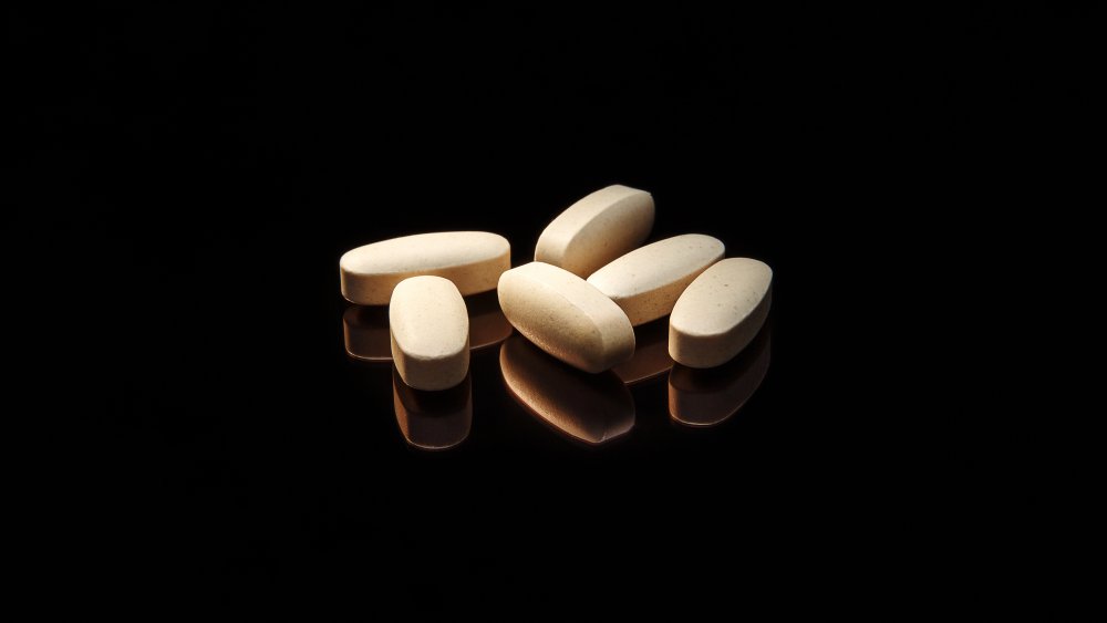 Vitamin pills on a black background