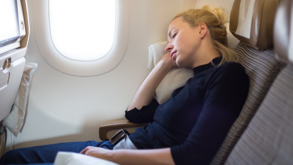 woman napping on plane