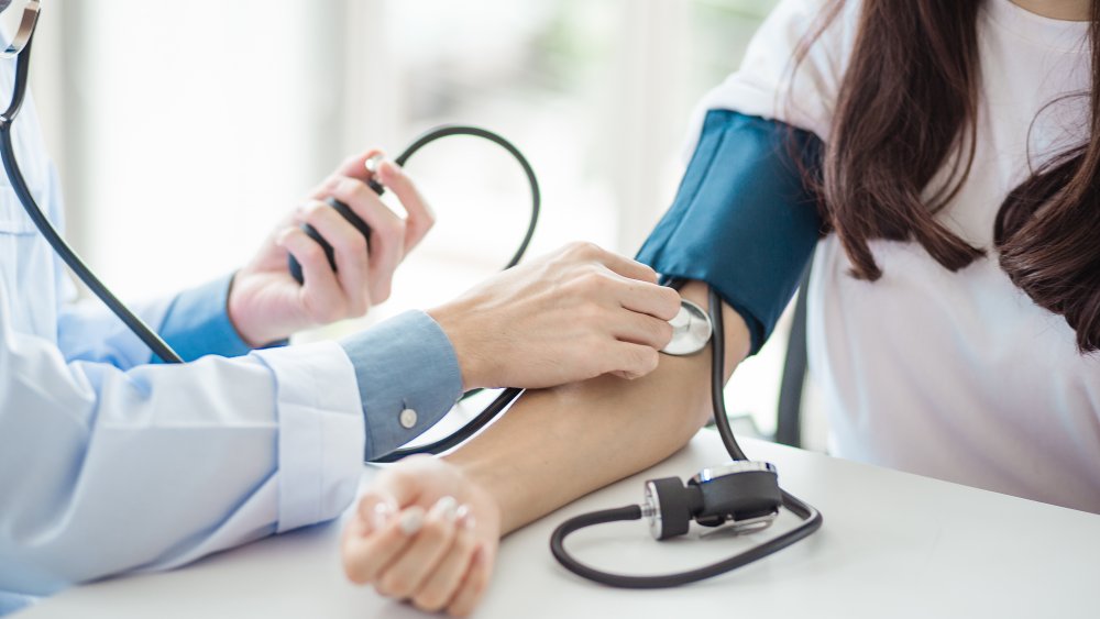 woman having her blood pressure checked