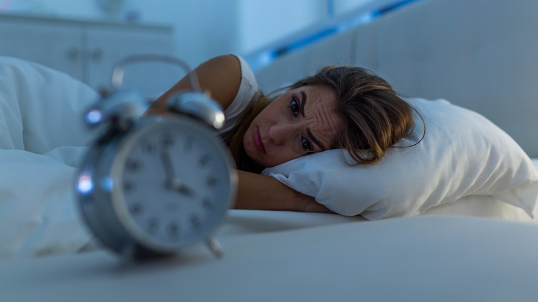 Woman awake staring at clock