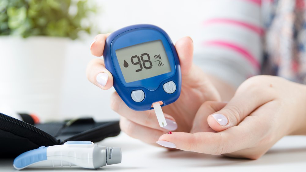 woman testing blood sugar