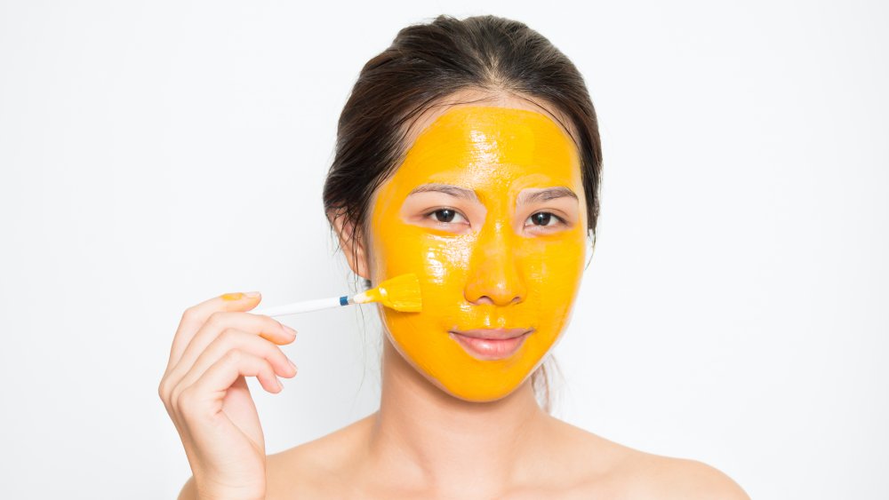 woman with turmeric face mask