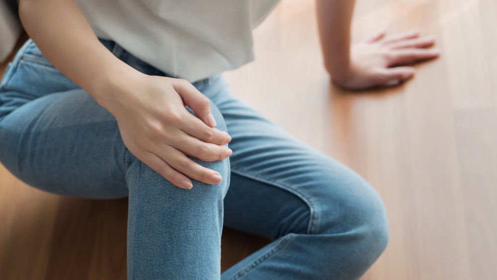 Close up on a woman's legs having knee pain