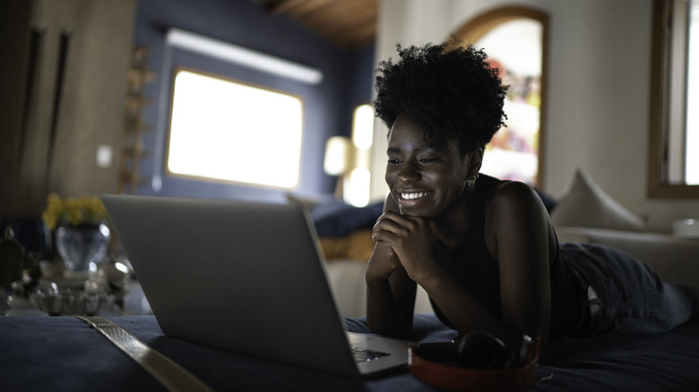 Woman watching Hallmark movies on a laptop