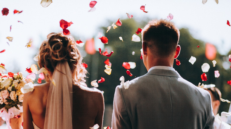 married couple showered in flower petals