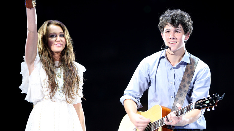 Nick Jonas and Miley Cyrus on stage