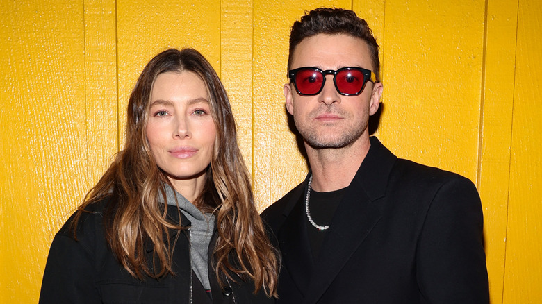 Jessica Biel and Justin Timberlake posing in front of yellow wall