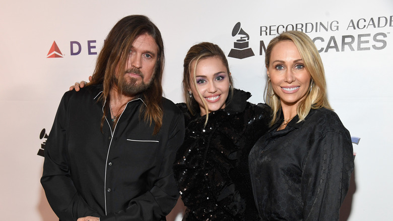 Miley Cyrus posing with her parents