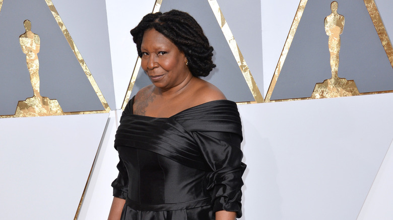 Whoopi Goldberg in a black dress at the Oscars